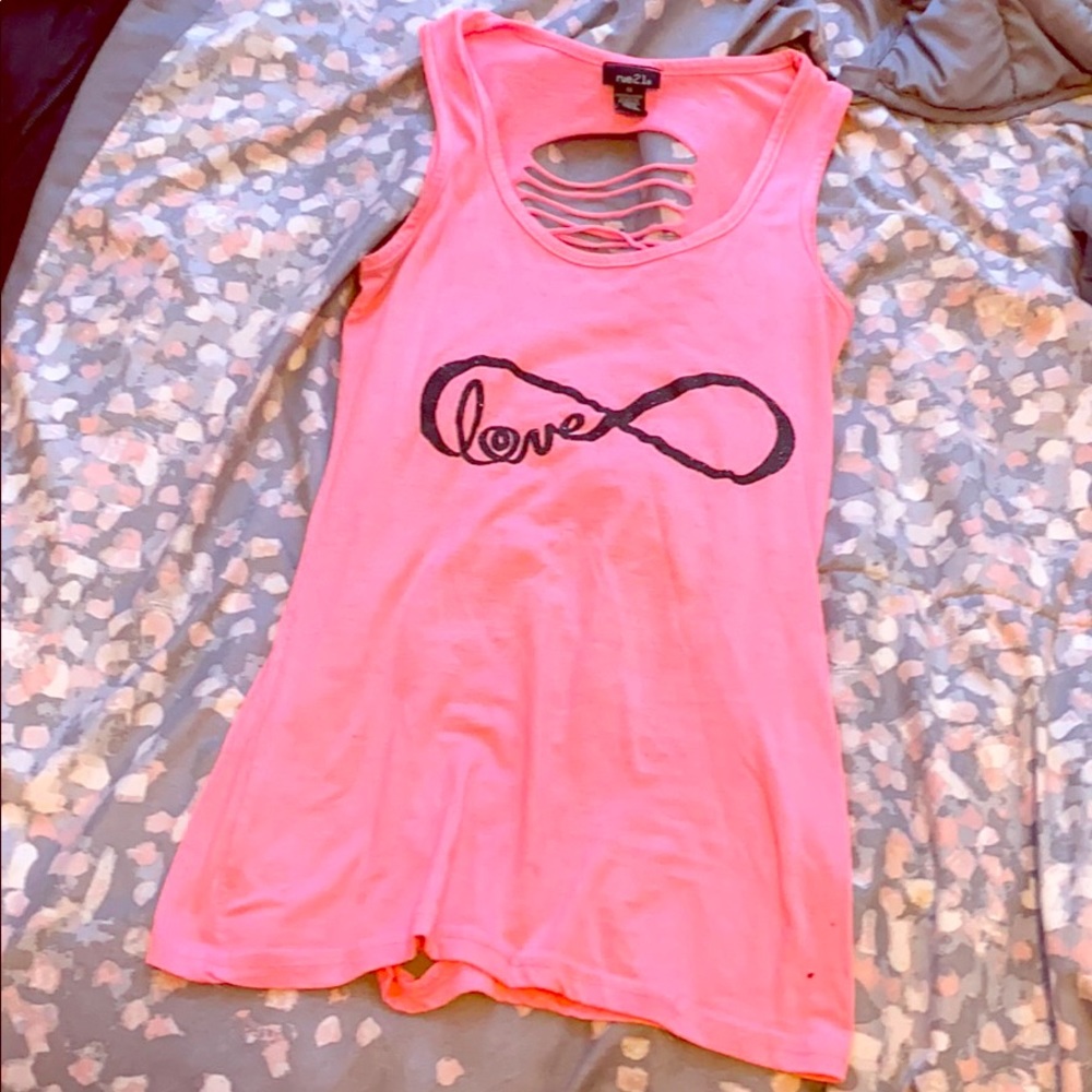 a pink shirt with cursive writing “love”.